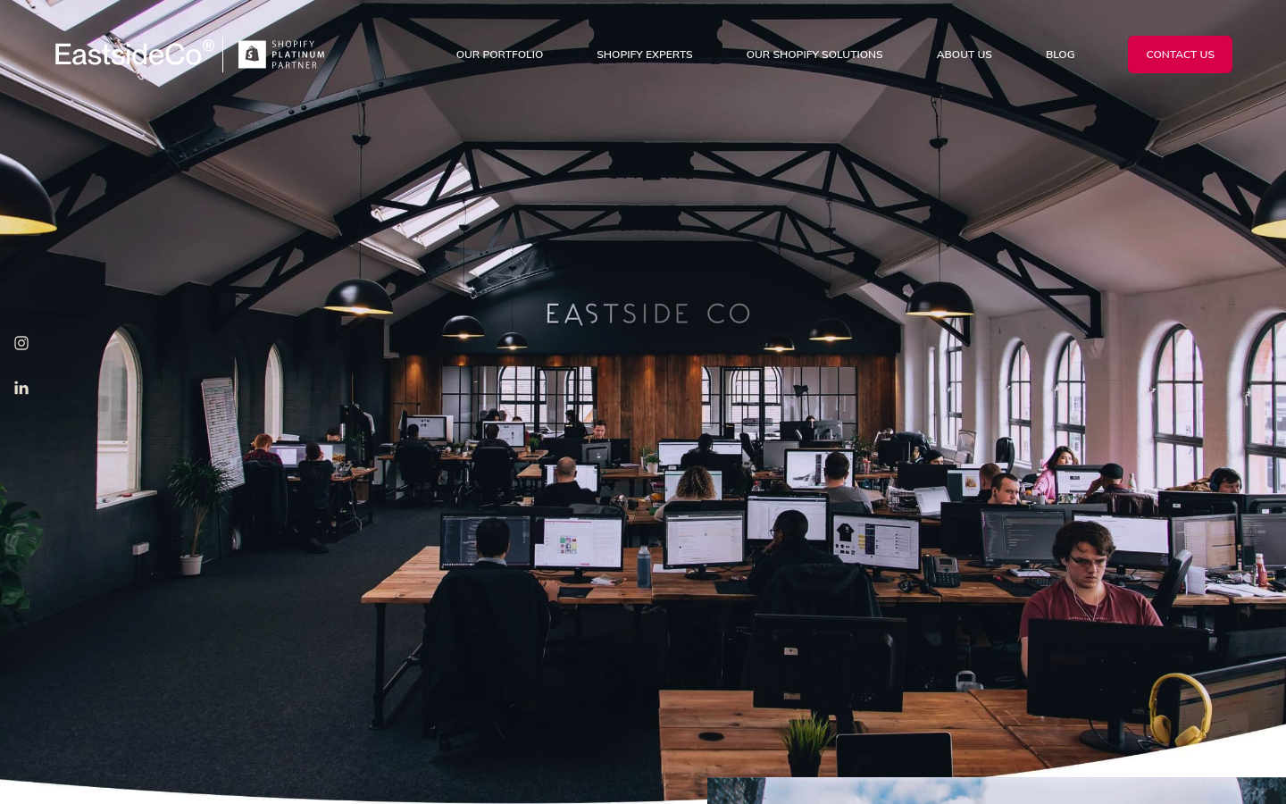 Eastside Co about page with a wide photo of the team working at desks in a converted warehouse-style office
